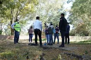 May be an image of 7 people, people standing, grass and tree